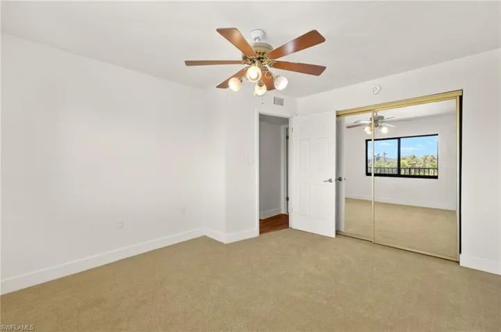 Unfurnished bedroom with carpet flooring, ceiling fan, and a closet