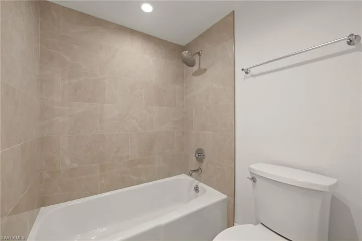 Full bath with washtub / shower combination and recessed lighting