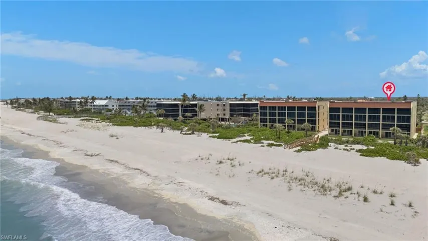 View of building exterior with view of water and beach