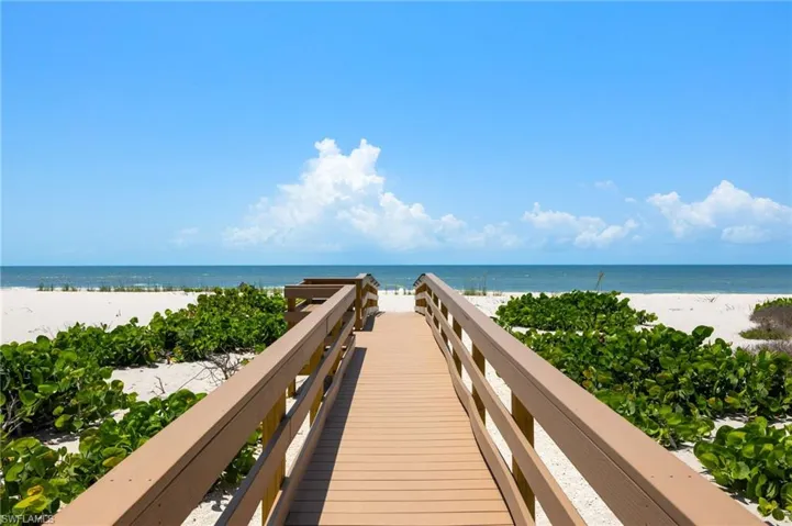 View of home's community with view of water and beach