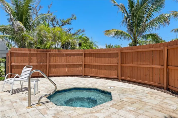 View of swimming pool featuring an in-ground hot tub, a fenced backyard, and a patio