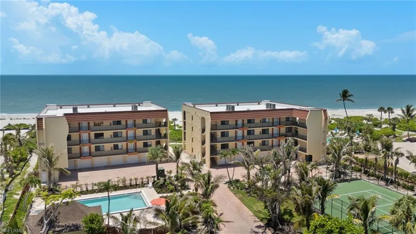 Bird's eye view of waterfront with a beach and a pool area