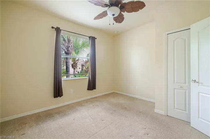 Light-colored carpeted flooring with a contrasting baseboard