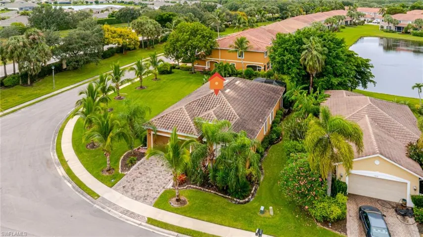 Single-story residence with a tiled roof, paver driveway, and an attached garage