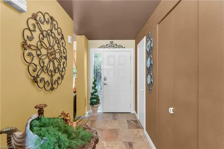 Foyer entrance featuring stone finish floor
