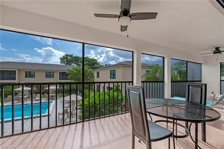 Oversized screened-in lanai overlooking community pool.