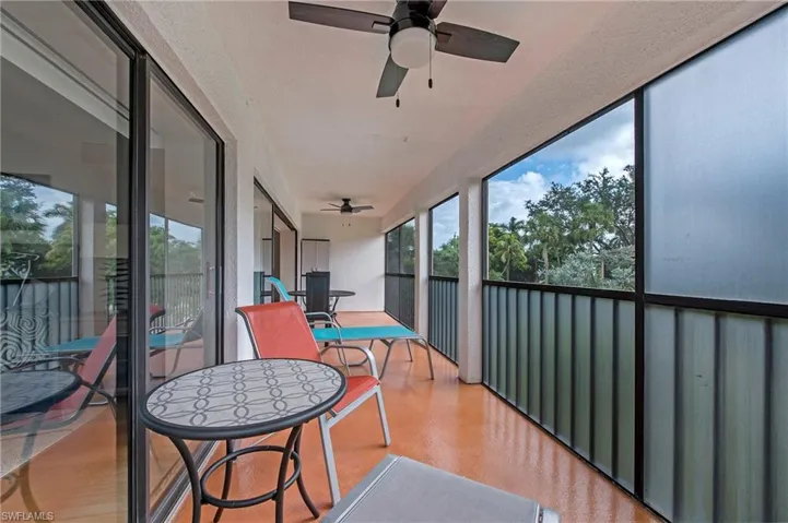 Oversized screened-in lanai with lots of seating.