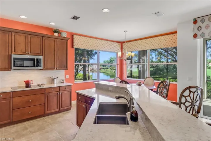 Kitchen with breakfast bar and eat-in dining area, offering long views of the lake.