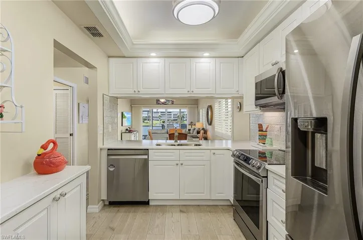 Lovely fully remodeled kitchen. New cabinets w/pullouts, lazy susan base cabinet, soft-close drawers and extra cabinets on the opposing wall from the refrigerator.