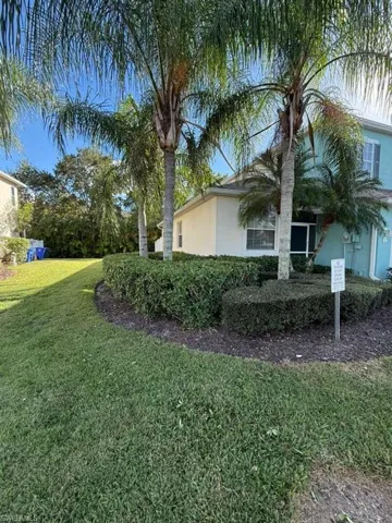 View of property exterior with stucco siding and a yard