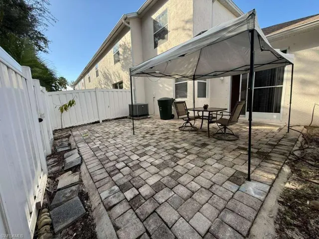 Fenced backyard featuring a patio, a gazebo, and outdoor dining space