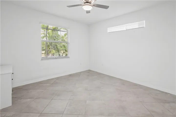 Master BedroomTile flooring, window with blinds, ceiling fan with integrated lighting