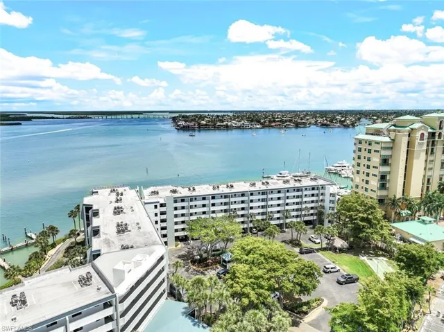Birds eye view of property with a water view