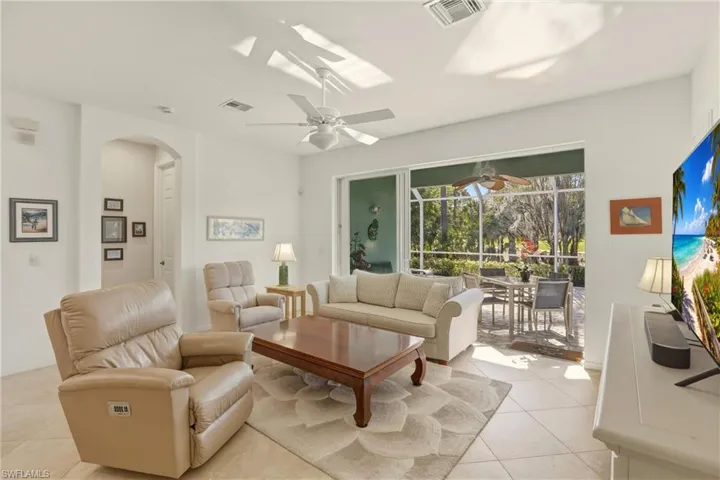 Open concept living area, with ceiling fan and tile flooring
