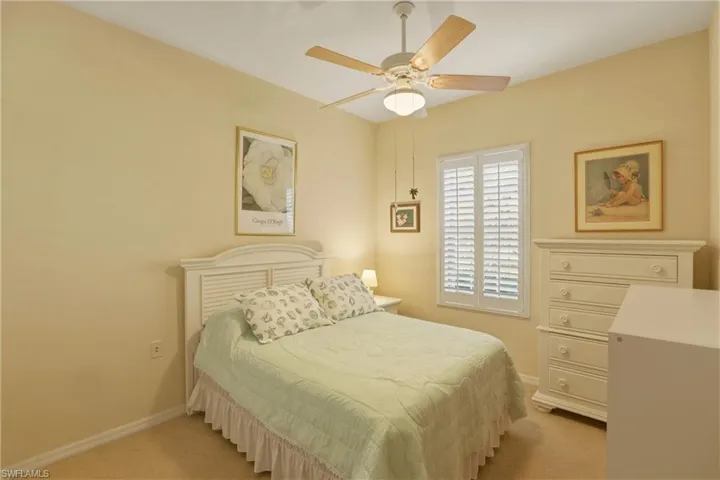 Guest Bedroom featuring a ceiling fan and plantation shutters