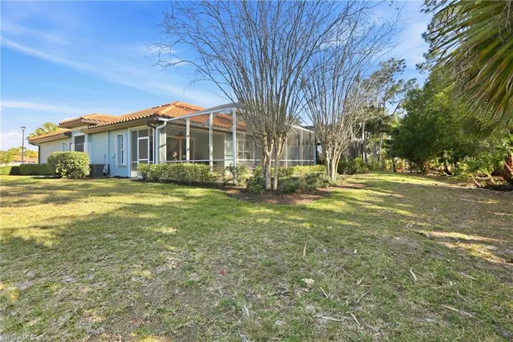 Back of house with a tile roof