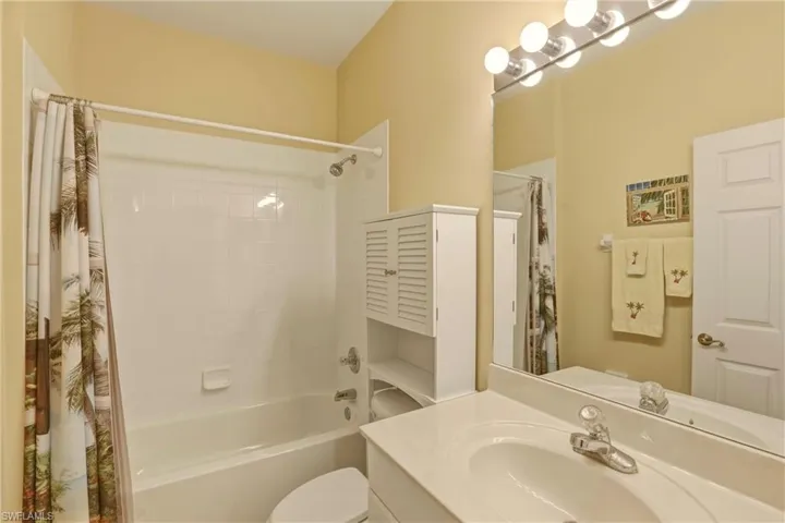 Full bath featuring vanity and shower / bath combo