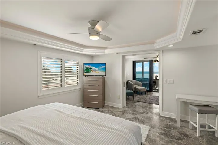 Bedroom featuring crown molding, ceiling fan, and a raised ceiling