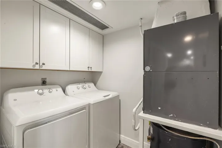 Washroom featuring cabinets and separate washer and dryer