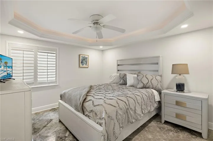 Bedroom featuring ceiling fan and a raised ceiling