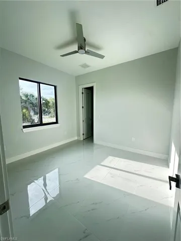 Spare room with ceiling fan