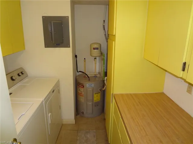 Inside laundry room with NEWER water heater, washer, dryer, a/c handler & loads of cabinets