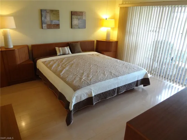 Huge master bedroom featuring hardwood / wood-style floors, ceiling fan & sliders to lanai. BIG water views