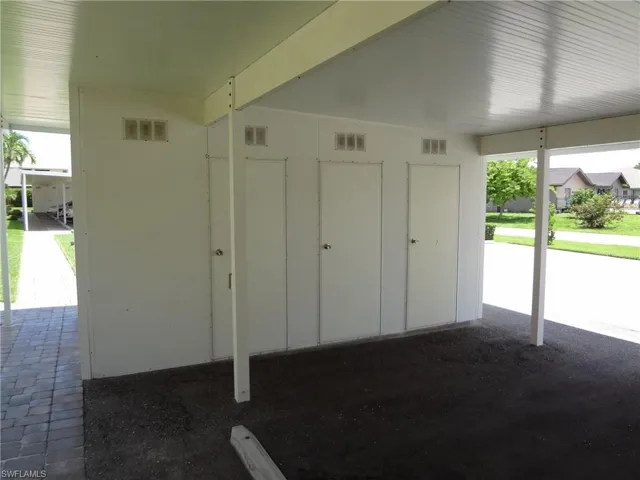 View of individual storage closets inside carport