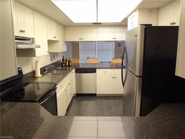 Kitchen with sink, loads of cabinets, pantry, refrigerator, dishwasher, range/oven, microwave & granite tops
