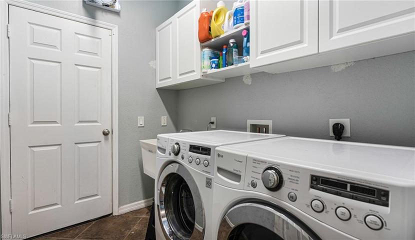laundry room with wash sink and plenty of storage