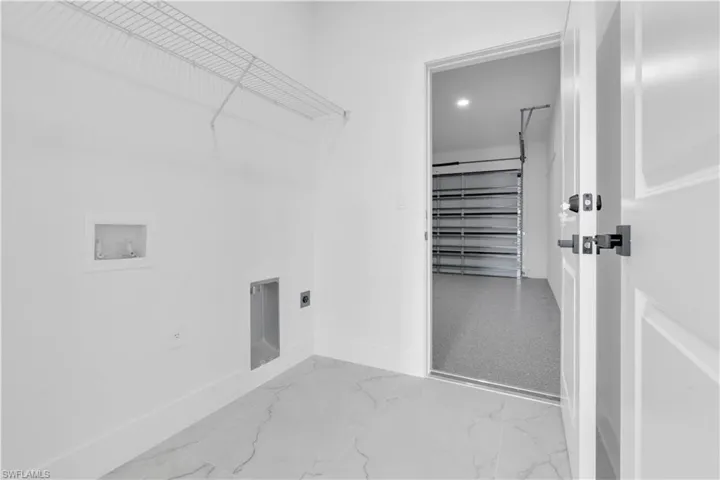 Washroom featuring washer hookup, recessed lighting, electric dryer hookup, and marble finish flooring