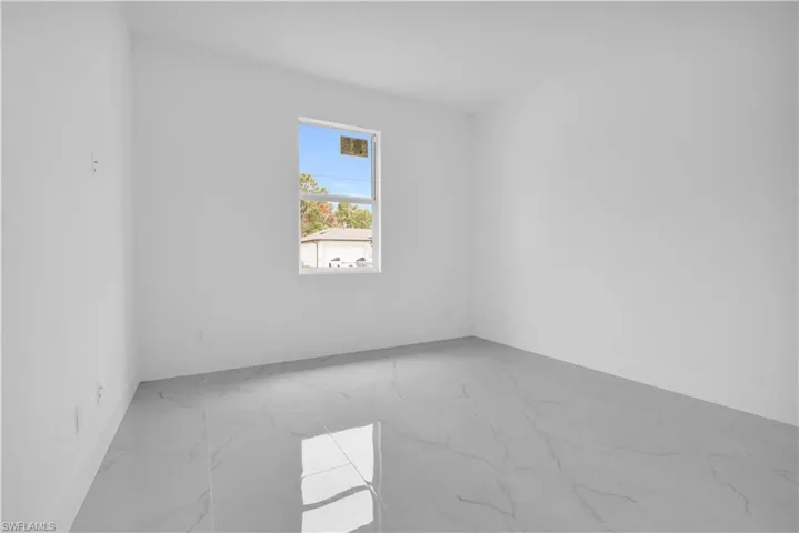 Empty room with light marble finish flooring and baseboards