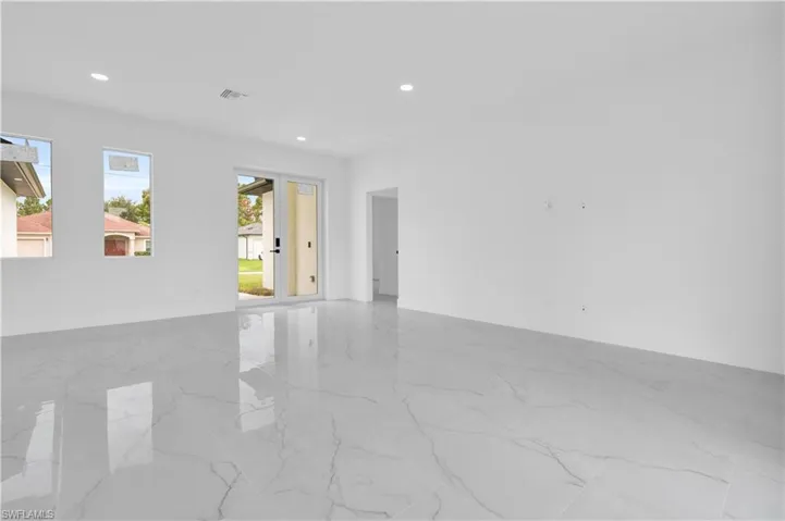 Unfurnished room featuring light marble finish floors and recessed lighting
