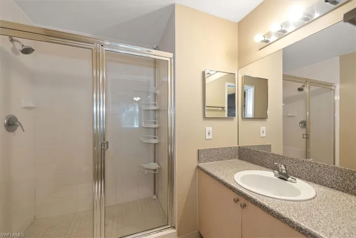 Full bath with vanity and a stall shower
