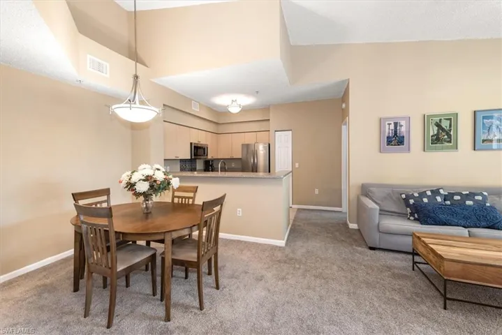 Dining space featuring corner shelf, and kitchen
