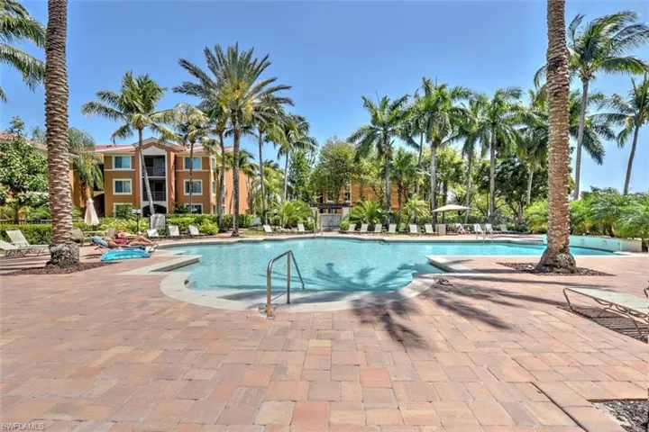 Community pool featuring a brick paver patio area