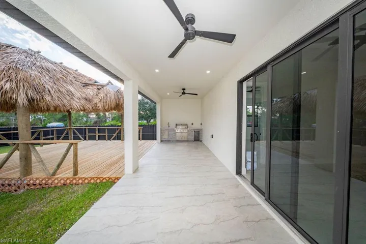 View of patio featuring area for grilling and a ceiling fan