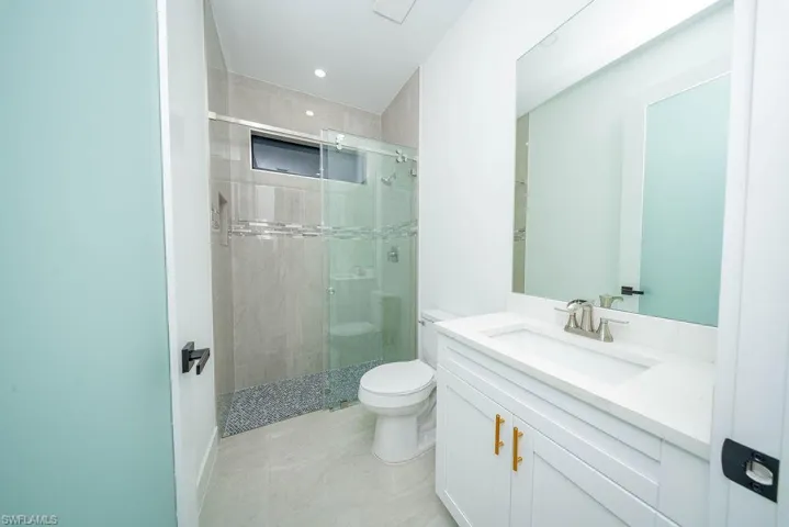 Bathroom featuring vanity, a stall shower, and recessed lighting