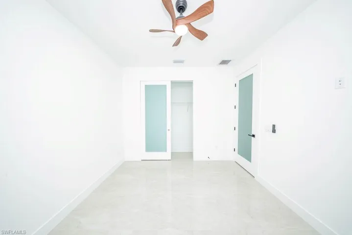 Unfurnished room featuring baseboards and a ceiling fan