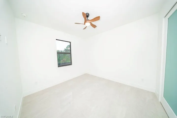 Spare room with baseboards and a ceiling fan