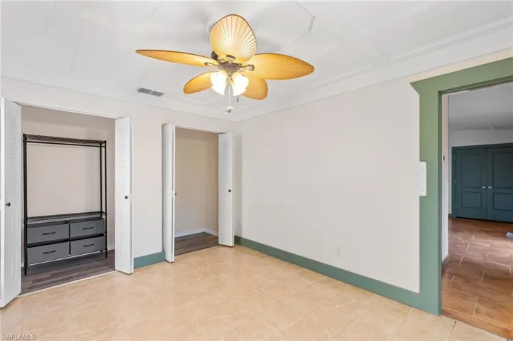 Unfurnished bedroom with tile patterned floors and ceiling fan
