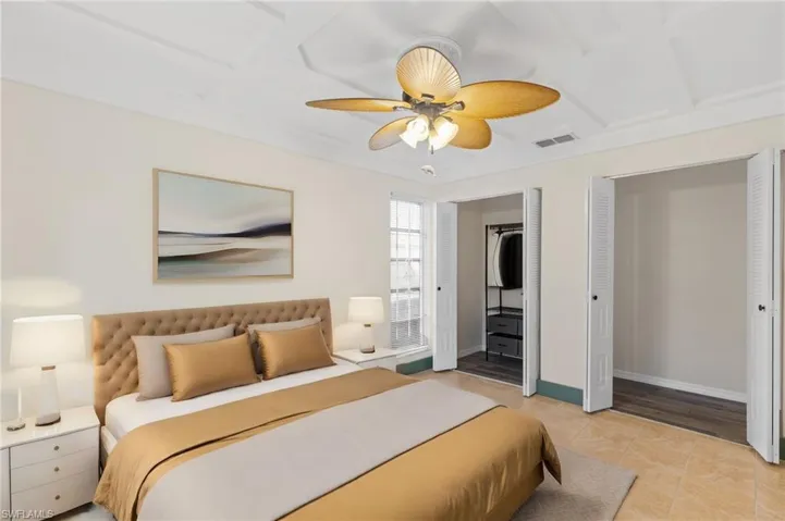 Bedroom with ceiling fan and light tile patterned floors