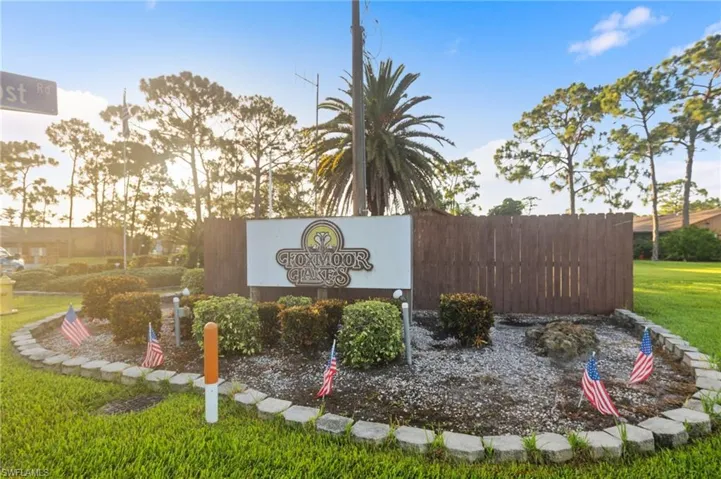 Community / neighborhood sign with a lawn