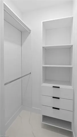Spacious closet with light marble finish flooring