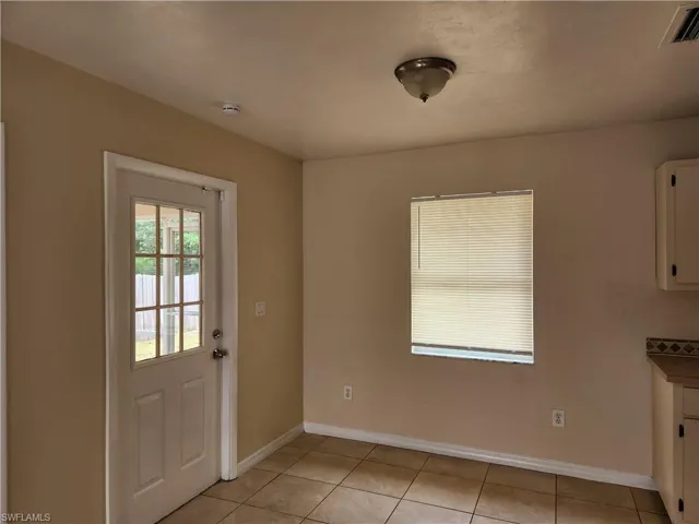 Unfurnished dining area featuring baseboards and light tile patterned floors