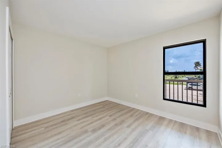 Bedroom with light wood-style flooring and baseboards