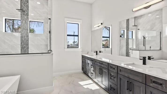 Dual sink vanity,soaking tub and glass enclosed walk in shower.