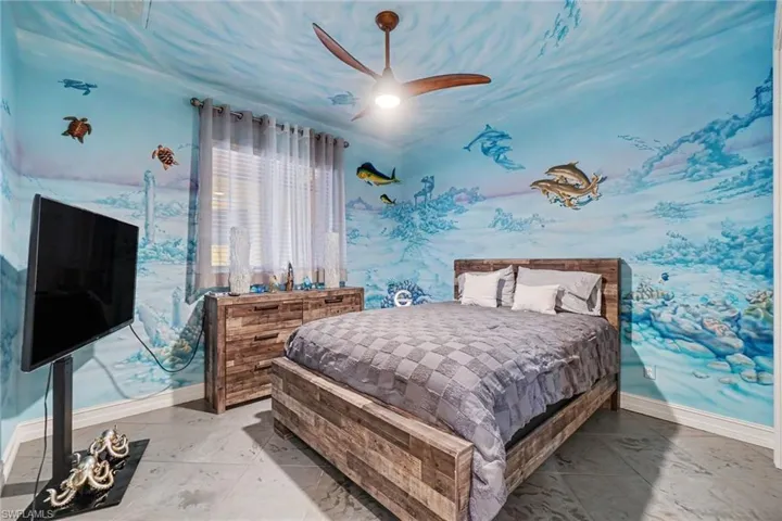 Room featuring custom underwater-themed wall and ceiling murals