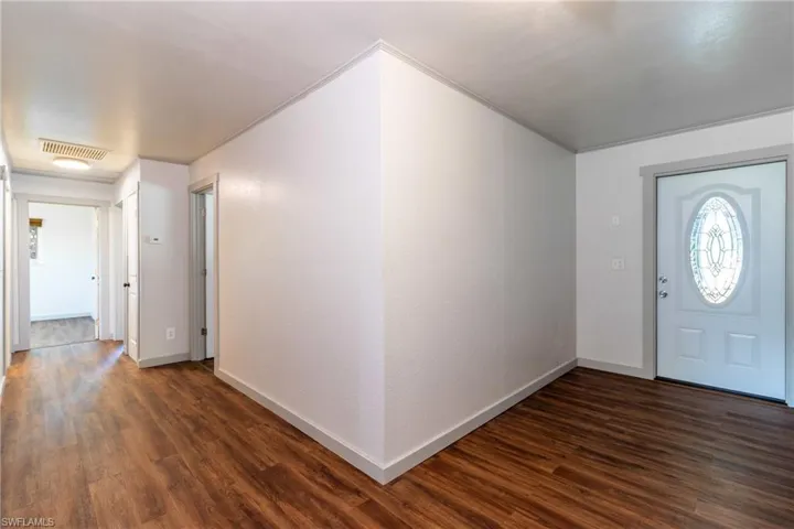 Foyer entrance featuring dark hardwood / wood-style flooring