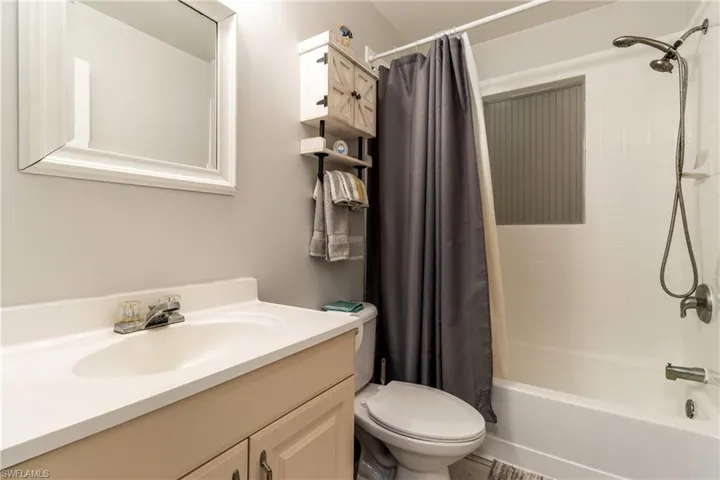 Full bathroom featuring shower / tub combo, toilet, and vanity